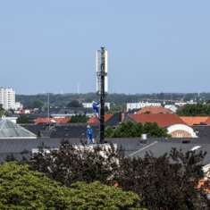 Techniker warten Mobilfunkantennen auf dem Hausdach